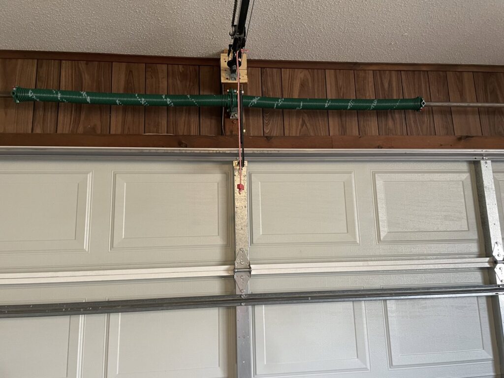 Close-up view of a garage door torsion spring system, a common repair by Precision Door Service of Huntsville, AL.
