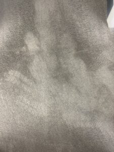 A close-up view of a grey carpet showing fresh cleaning lines from USA Clean Master in Baltimore, MD