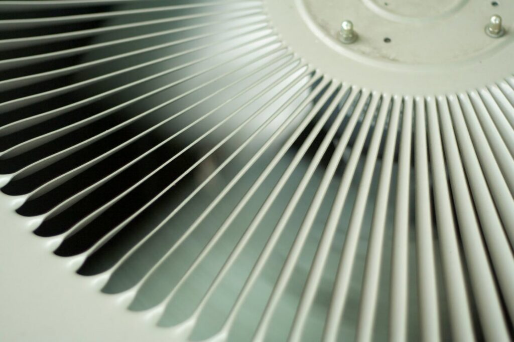 A close-up view of the fan on an outdoor HVAC unit, maintained by Surfside Heating & Cooling in Cape Coral, FL.