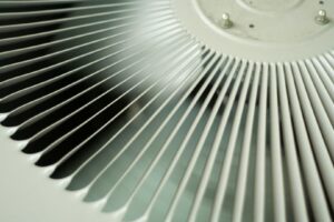 A close-up view of the fan on an outdoor HVAC unit, maintained by Surfside Heating & Cooling in Cape Coral, FL.