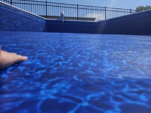 A close-up view of a new blue pool liner, highlighting quality liner installation by Westside Pools in Owensboro, KY.
