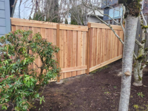 A close-up view of a newly installed wood privacy fence section by Howell Fence Inc. in Oregon City, OR.