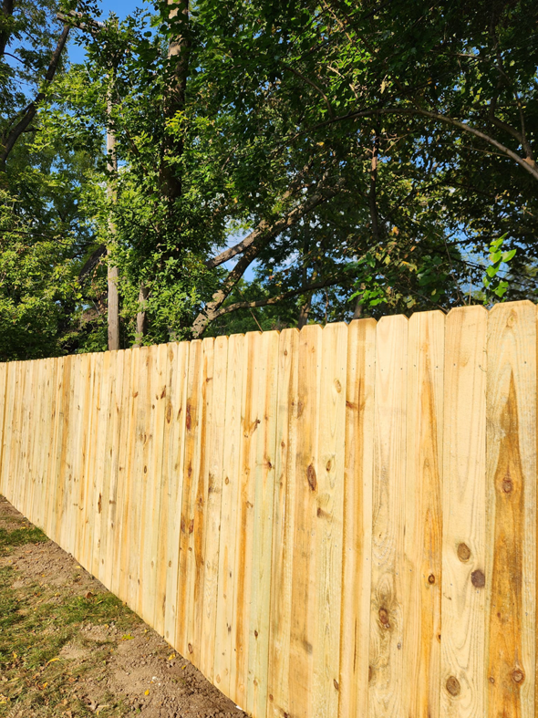 A close-up view of a newly installed wooden privacy fence showcasing the quality of work by Tussing's Fence in Ann Arbor, MI.
