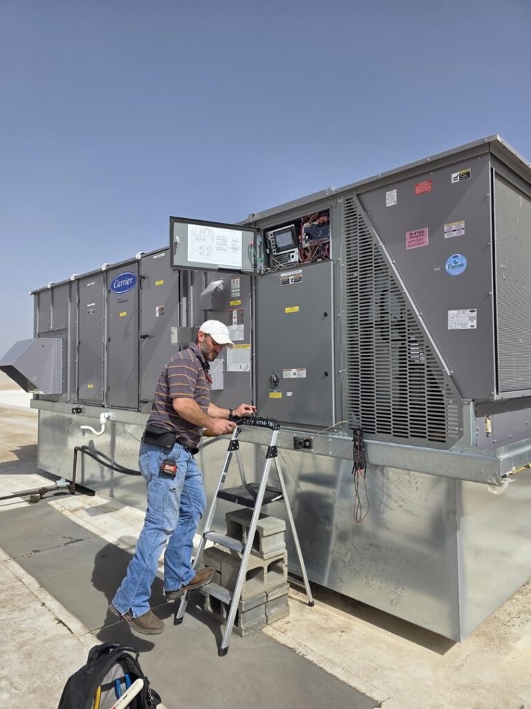 A close-up view of an outdoor air conditioning unit's fan, representing cooling services by 24/7 Heating & Air, LLC in Grand Island, NE.