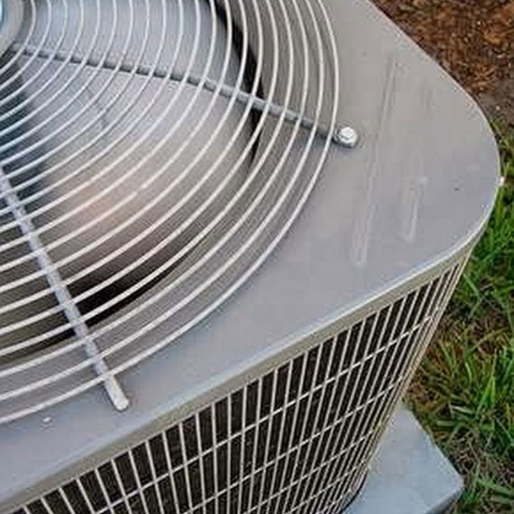 A close-up view of the fan and top of an outdoor AC unit, serviced by Dodson A/C & Appliance in Biloxi, MS.