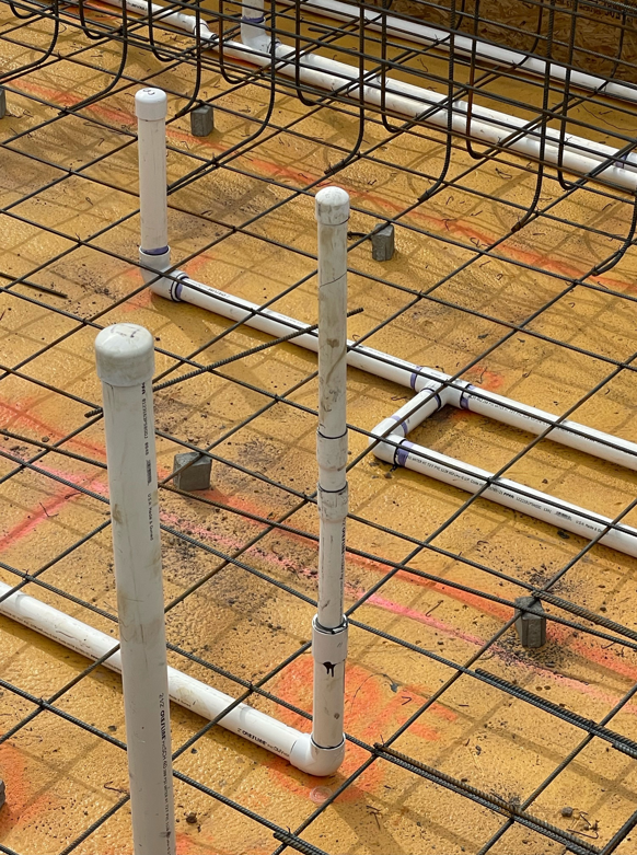 Close-up of pool plumbing and rebar grid during construction by SoCal Pool Construction LLC in Scottsdale, AZ.