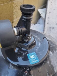 Close-up of a black pool pump component with an NSF sticker, showing equipment service and repair by Perezidential Pools Service & Repair in Phoenix, AZ.