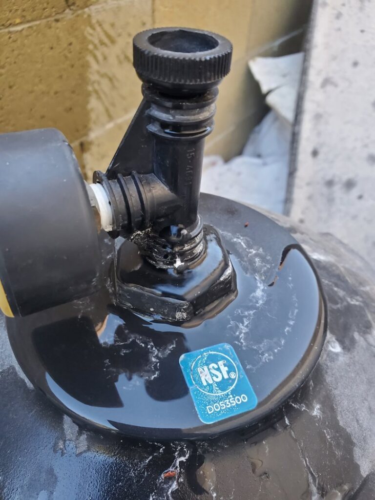 Close-up of a black pool pump component with an NSF sticker, showing equipment service and repair by Perezidential Pools Service & Repair in Phoenix, AZ.