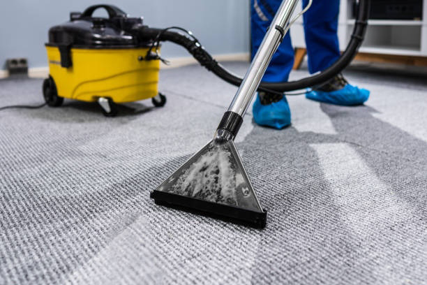 A close-up of a professional carpet cleaning wand removing dirt from a grey carpet by Spears Americare in Hopkinsville, KY.