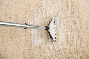 A close-up view of a professional carpet cleaning wand extracting suds from a carpet by Spears Americare in Hopkinsville, KY.