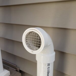 A close-up view of a PVC vent cap with a screen, part of an HVAC system installed by A-OK Heating & Cooling in Concord, GA.
