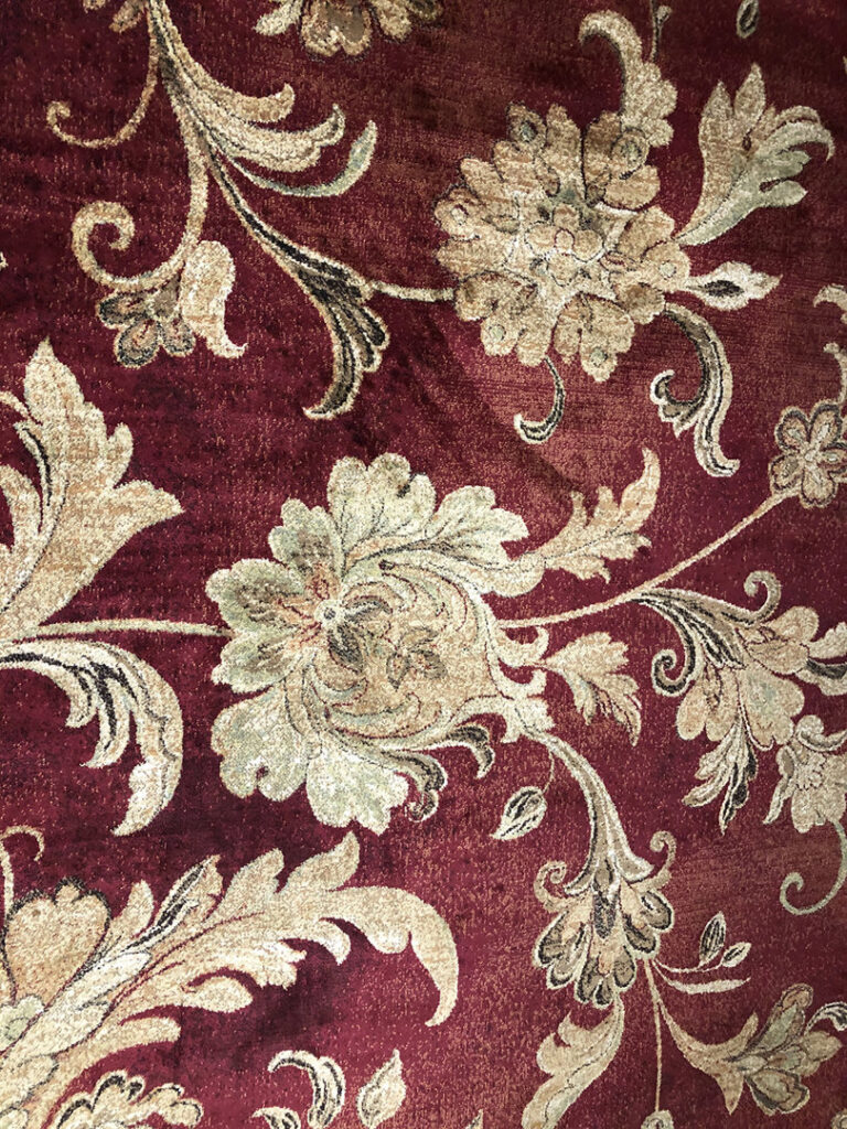 A close-up view of a red patterned rug available at Rug Masters in Charleston, SC.
