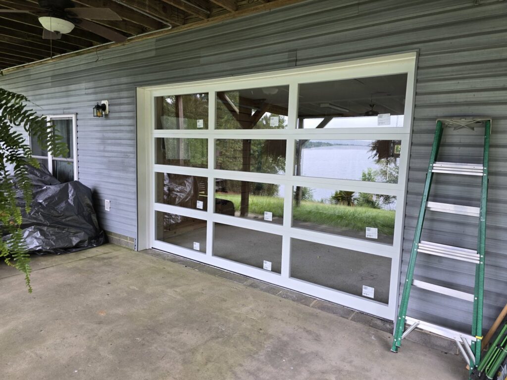 A close-up view of a residential glass garage door installed by Coles Garage Door Service, LLC in West Columbia, SC.