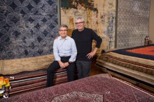 A close-up view of a white rug being thoroughly cleaned with foam at American Rug Laundry in Saint Paul, MN.