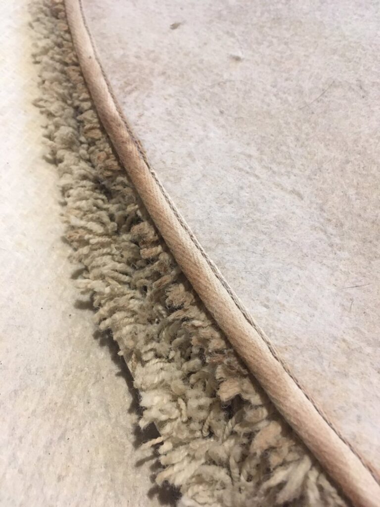 Close-up view of a rug edge with professional binding, showcasing quality craftsmanship at Zakian Rug Cleaning in Philadelphia, PA