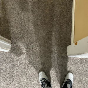 A close-up view of a clean, grey carpeted floor, demonstrating quality work by HK Carpet Doctors in Sterling Heights, MI