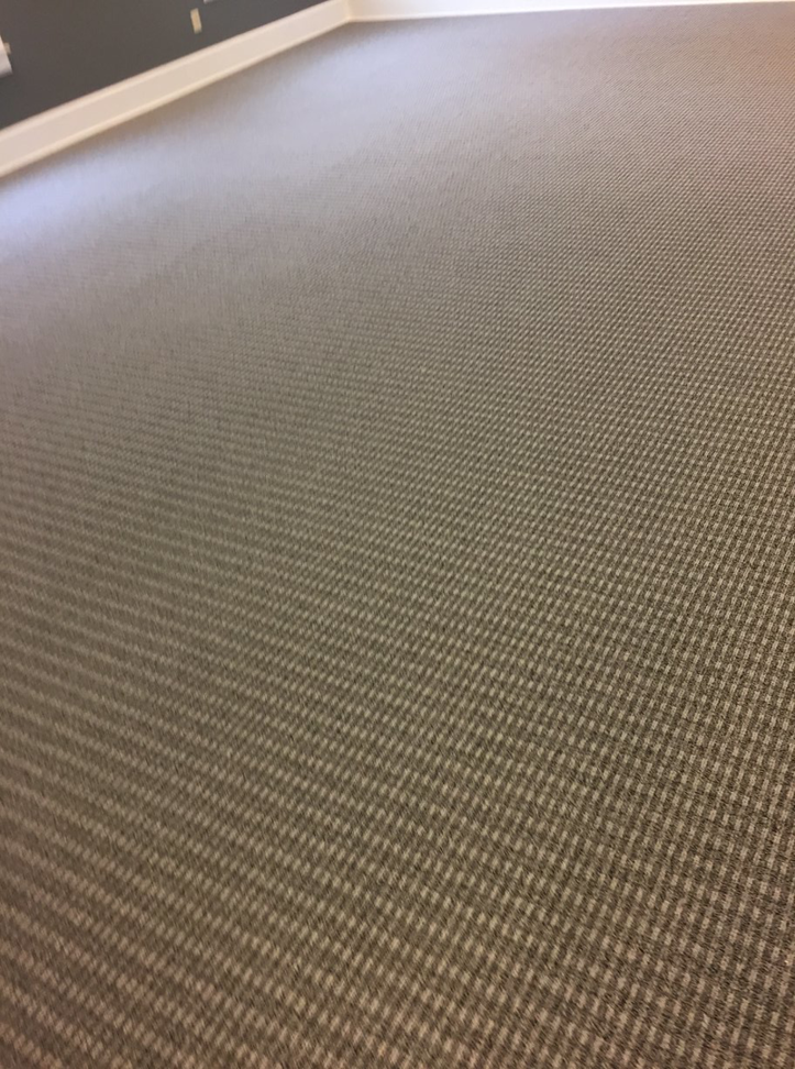 A close-up view of a professionally installed patterned carpet floor by Tony Trujillo Flooring Sales & Installation in Franklin, TN.
