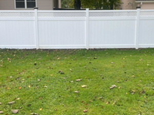 A close-up view of white vinyl fence panels with a decorative lattice top installed by Fence Guys INC in Cleveland, OH.