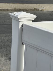 A close-up view of a white vinyl fence post and panel, showcasing quality work by Profence in Leander, TX.