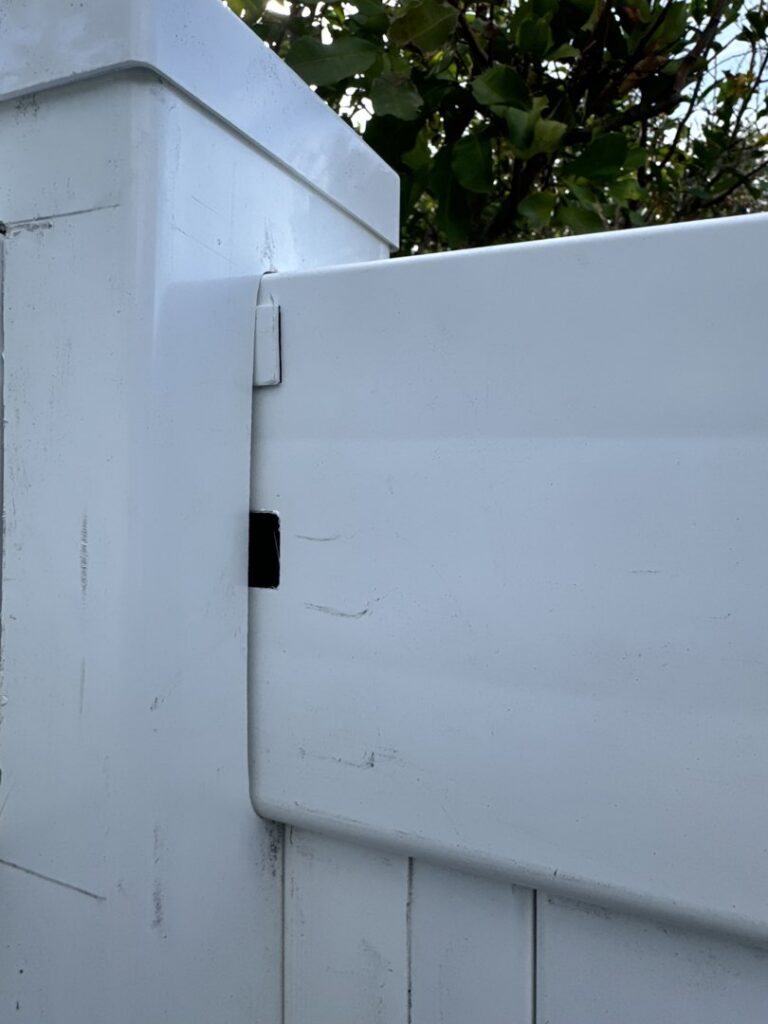 A close-up view of a white vinyl fence post and panel connection by Santis Fence & Home Service in Tampa Heights, FL