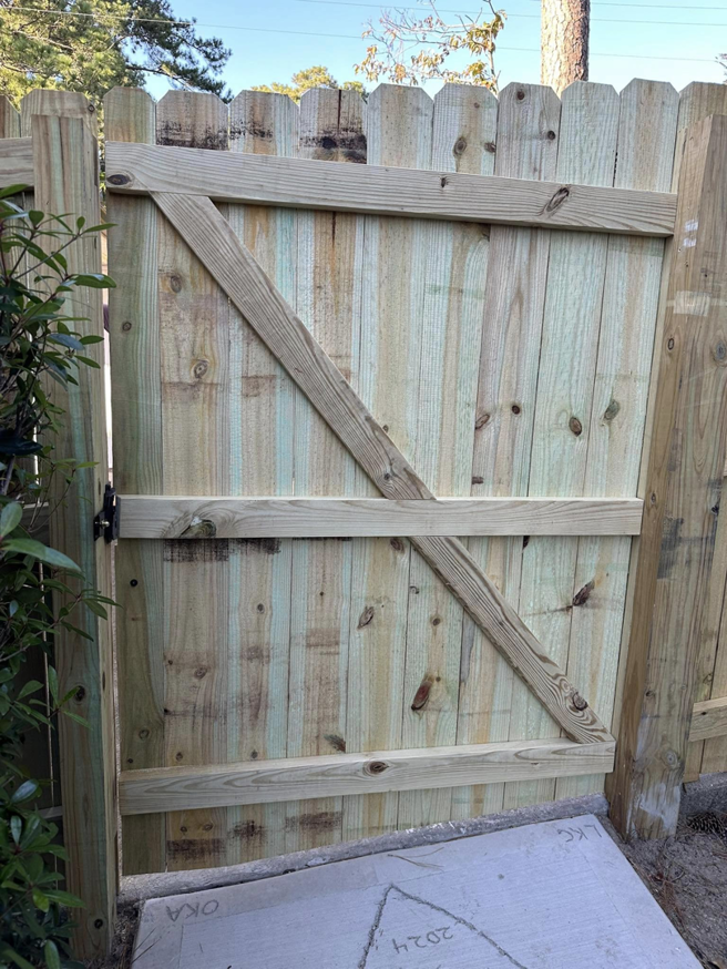 Close-up view of a newly constructed wood fence gate by First in Fencing and Remodeling in Fayetteville, NC.
