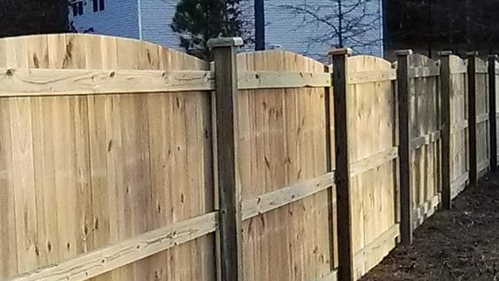A close-up view of a completed wood privacy fence installed by Rowe Fence & Supply in New Kent, VA.