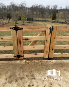 A close-up view of a custom wooden gate with decorative black hinges and latch, installed by Fairway Fencing in Lexington, KY.