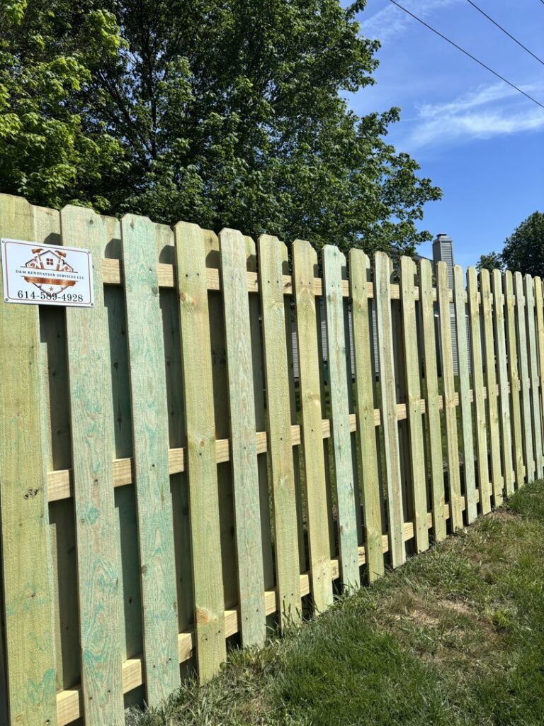 A close-up view of a newly installed wooden privacy fence, showcasing the work of D&M Renovation Services LLC in Columbus, OH.