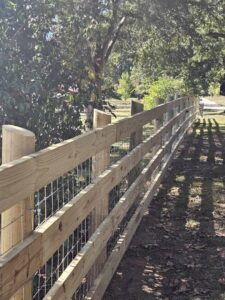 Close-up of a newly installed wooden split-rail fence with wire mesh by National Fence and Gate in Ironton, MO.