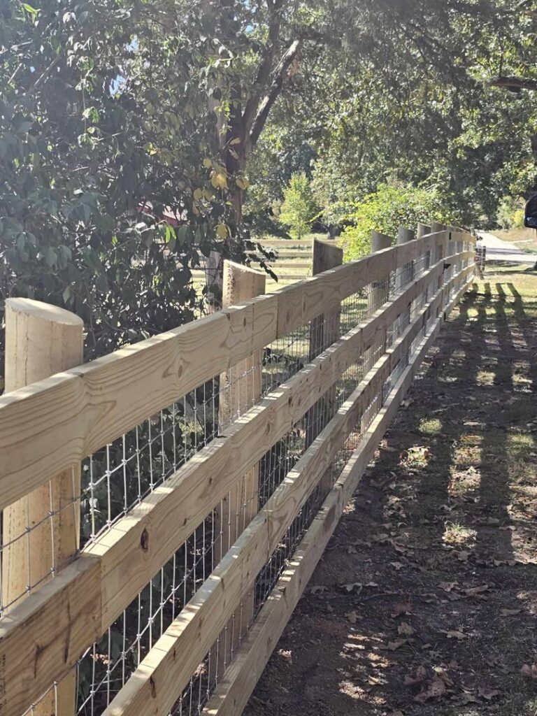Close-up of a newly installed wooden split-rail fence with wire mesh by National Fence and Gate in Ironton, MO.