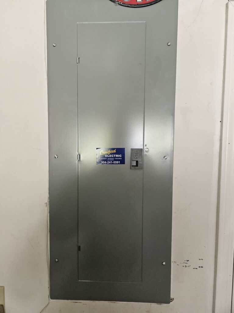 A closed electrical panel or breaker box with a Crawford Electric Services, LLC sticker in Kings Mountain, NC.