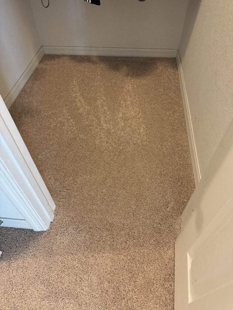 A small closet with newly installed light brown carpet by First Quality Carpets Inc. in Orlando, FL
