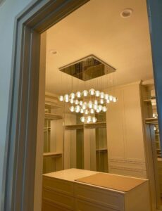 A beautiful multi-bulb chandelier installed in a walk-in closet by J&M Electrical Services in Stockbridge, GA.
