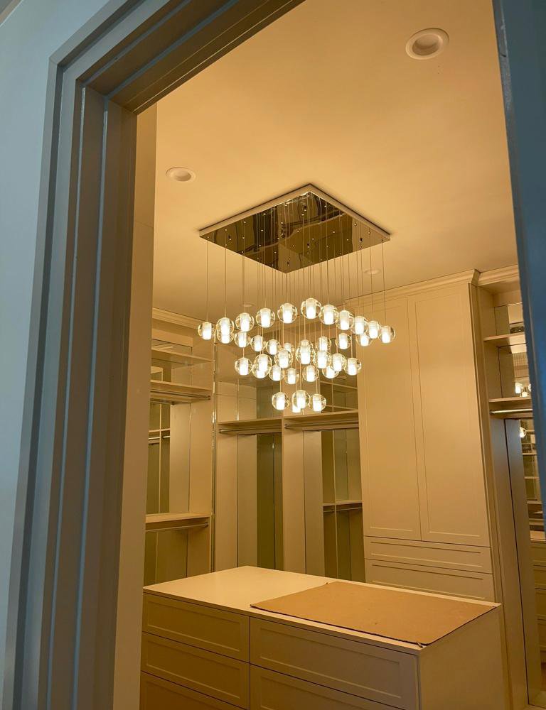 A beautiful multi-bulb chandelier installed in a walk-in closet by J&M Electrical Services in Stockbridge, GA.