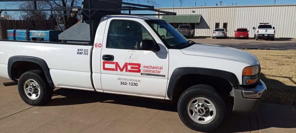 A CM3, Inc. mechanical contractor truck parked outside a commercial building in Wichita, KS.