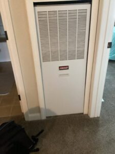 A Coleman furnace unit installed in a utility closet by Advanced Home Services in Rigby, ID.