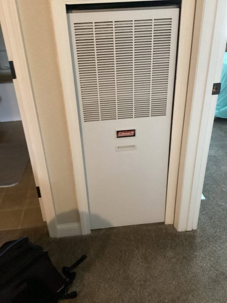 A Coleman furnace unit installed in a utility closet by Advanced Home Services in Rigby, ID.