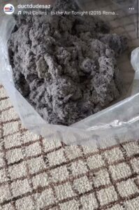 A large pile of lint and dust collected in a clear bag after a cleaning service by Duct Dudes in Scottsdale, AZ.