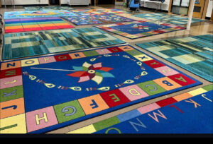 Several colorful area rugs laid out after professional cleaning, ready for use by Ype Cleaning LLC in Monroe, NC.