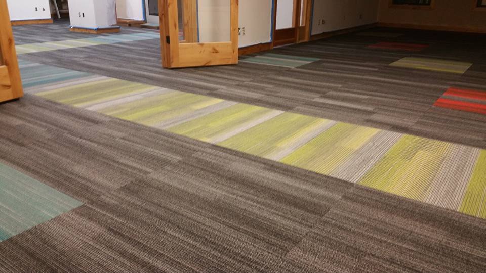 Colorful carpet tile installation in progress, showcasing a job by Bozeman Flooring in Bozeman, MT.