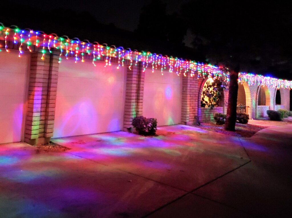 Colorful Christmas lights professionally installed on a house by GET LIT Electrical Services LLC in Glendale, AZ.