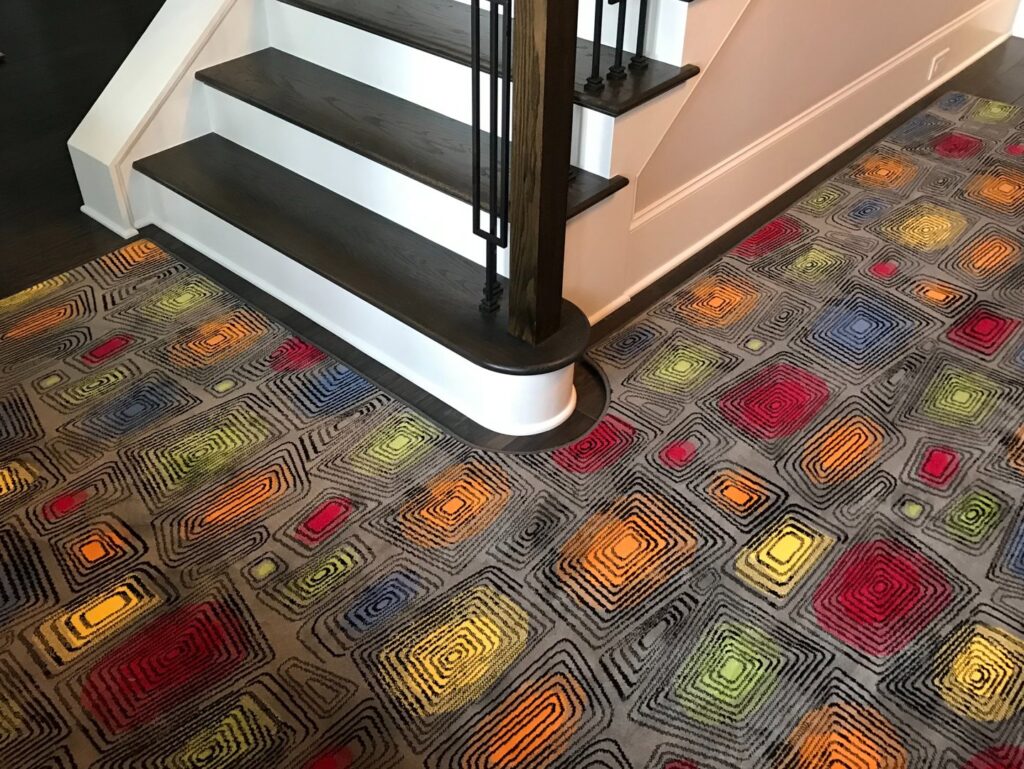 A vibrant, colorful patterned area rug installed on a landing by Carpet Binding Company in Charlotte, NC.