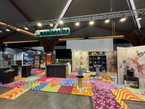 A vibrant, colorful patterned carpet installation at an exhibition booth by Montecolino s.p.a. in Iseo, IT.