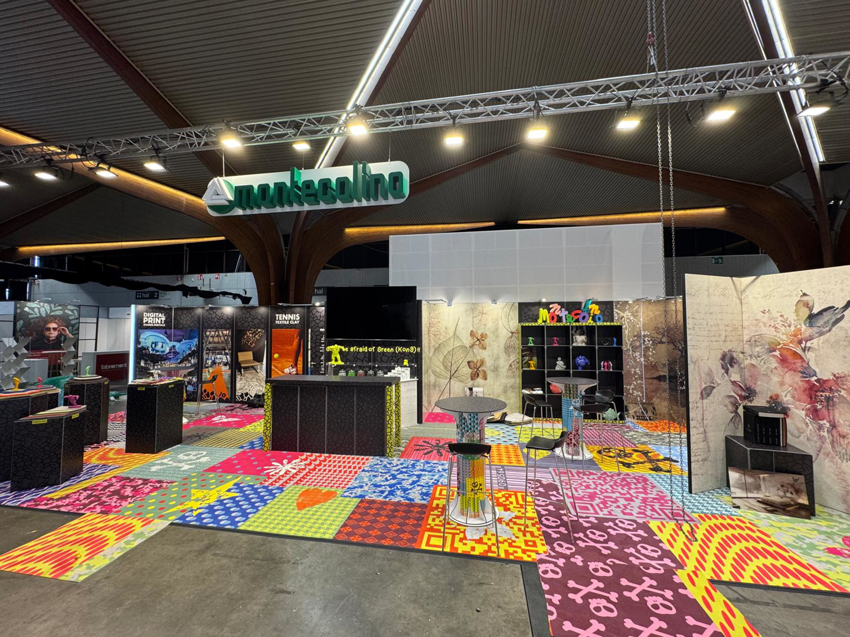 A vibrant, colorful patterned carpet installation at an exhibition booth by Montecolino s.p.a. in Iseo, IT.