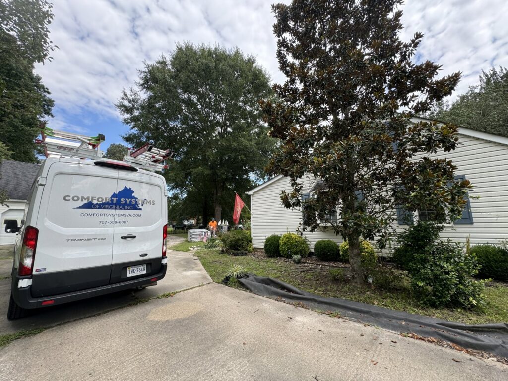 A Comfort Systems of Virginia, Inc. HVAC service van parked at a residential home in Chesapeake, VA.