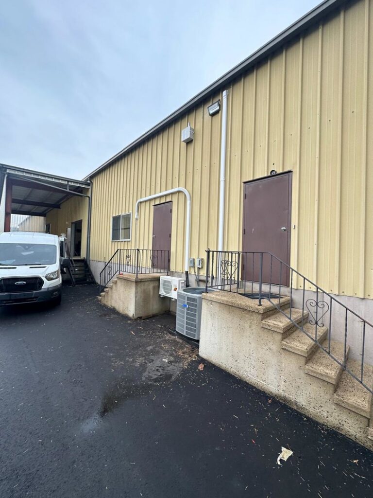 An outdoor commercial AC condenser unit next to a building by Express Home Services LLC in Las Vegas, NV