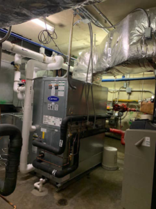 A large commercial Air Handling Unit (AHU) with extensive ductwork installed by Allstate Heating & Cooling in Lexington, KY.