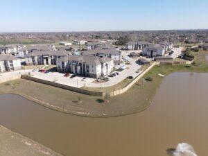An aerial view of a new wood fence installation surrounding an apartment complex, completed by Fence Builders of Houston, TX.