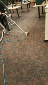 A professional cleaning commercial area carpets for Harper's Cleaning Services in Anaheim, CA.