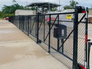 A commercial black chain-link fence with an automated gate system by Nash Fence & Supplies Inc. in Lake Charles, LA.